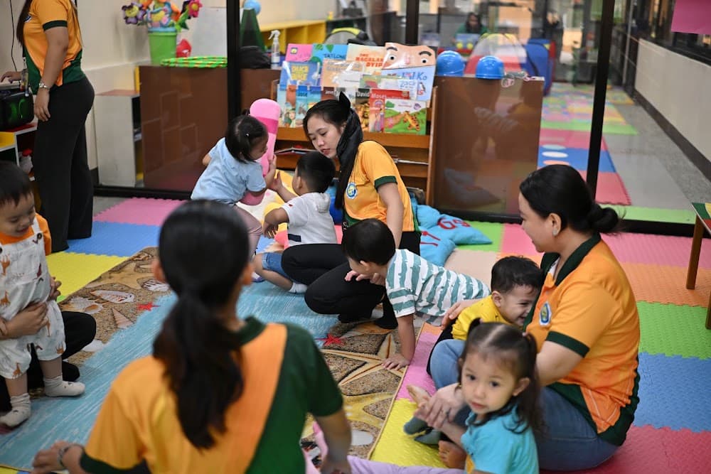 Children walking together indoors with a teacher