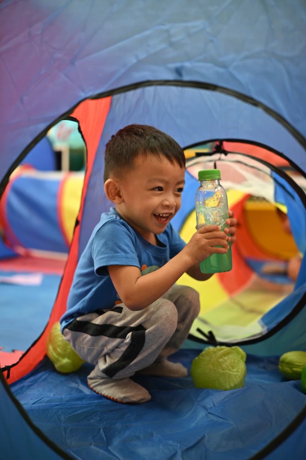 A girl using a sponge for a water play activity