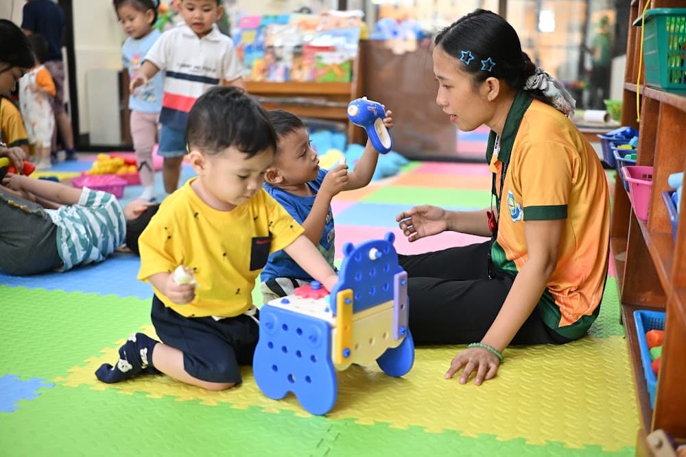 A teacher guiding two boys through a wooden educational toy
